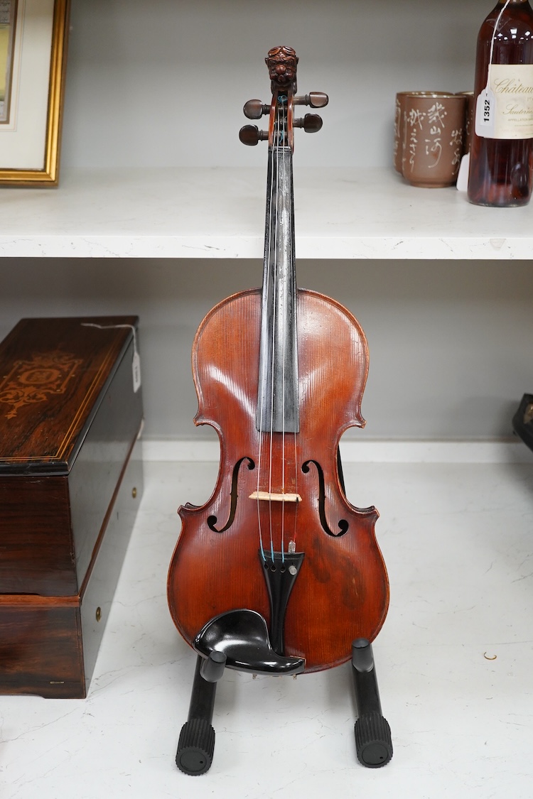 A cased late 19th century German Mittenwald violin with lion’s head scroll, and two bows, Ivory submission ref: RP2E5HT1